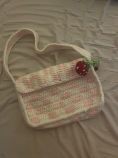 a crocheted purse sitting on top of a bed