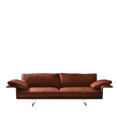 a brown leather couch sitting on top of a white floor