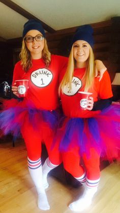 two girls dressed in red and purple tutus posing for the camera with their mugs