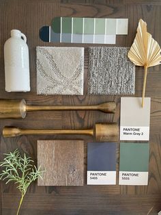 the wooden table is covered with different shades of paint and wood utensils on it