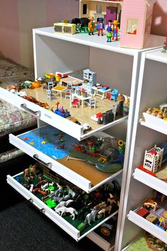 the shelves are filled with toys and other things to play with in their bedroom area