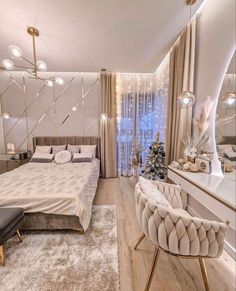 a bedroom decorated in white and gold with a bed, chair, desk, mirror and christmas tree