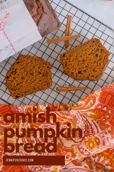 two muffins sitting on top of a cooling rack next to paper bags and cinnamon sticks