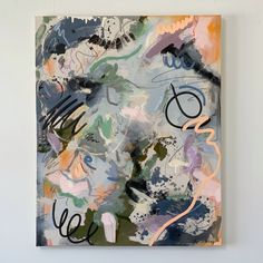 an abstract painting on a white wall