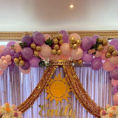 a decorated stage with balloons and flowers on it