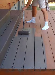 a man is cleaning the deck with a mop