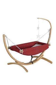 a red hammock with stars hanging from it's sides and a wooden stand