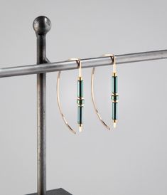 Unique original designed hoops with green hematite beads, in shades of green and amber.  The green beads have some varying tones of medium green, and pair well with the gold wire. Handmade in my studio, all of my jewelry is carefully crafted with attention to detail, each piece is a unique design and a one of a kind gift. Details at a glance >Comfortable 20 gauge 14K gold filled ear wire. >14K Gold filed beads/Green hematite Beads.        >Length is 1.75" or 44 mm. >Polished finish, hammered end How To Make Metal Jewelry, Fall Winter 2024/2025 Jewelry Trends, Gold Wire Jewelry, Earwires Handmade, Two Tone Jewelry, Unique Jewelry Vintage, Wire Earrings Handmade, Hoop Earrings Handmade, Earring Inspiration