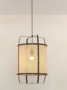 a light fixture hanging from the ceiling in a room with white walls and flooring