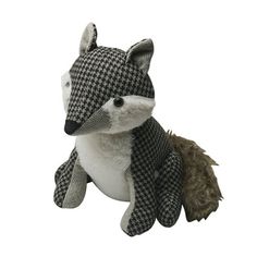 a stuffed animal with a scarf around it's neck sitting on a white surface