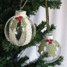 two christmas ornaments hanging from a tree with white and green polka dot designs on them