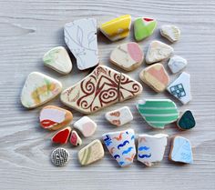 several different colored and shaped cookies on a wooden table with one cookie in the middle