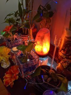 there are many flowers and candles on the table with some lights in the back ground