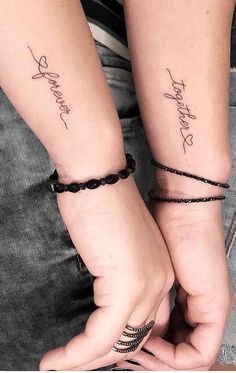 two people holding hands with tattoos on their arms that say, happy birthday and love