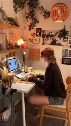 a woman sitting at a desk using a laptop computer