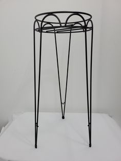 a black metal stand with four legs