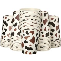 a stack of white and brown paper cups with black spots on the bottom, sitting next to each other