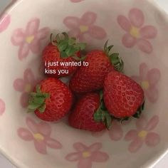 four strawberries in a bowl with the words i just wanted to kiss you