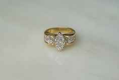 a three stone diamond ring sitting on top of a table