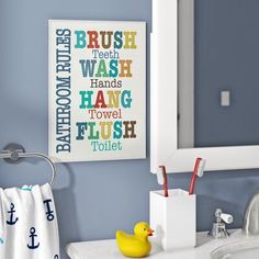 a bathroom with a sink, mirror and yellow rubber ducky toy in the corner