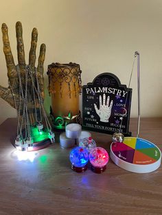 a wooden table topped with lots of different types of lights and items on top of it