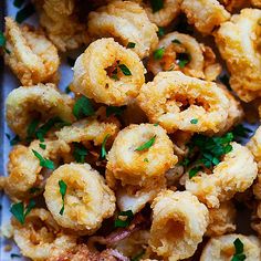 some fried food is on a plate with parsley sprinkled around the edges