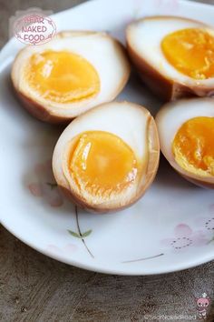 four eggs are sitting on a white plate