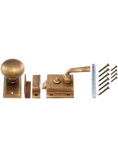 a brass door handle with screws and nails next to it on a white background