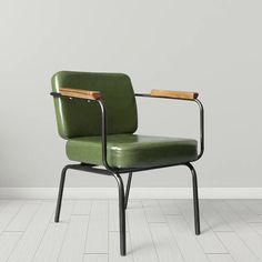 a green chair with a wooden arm rests against a white wall in an empty room