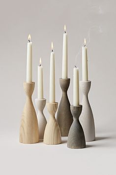 several wooden candlesticks lined up next to each other