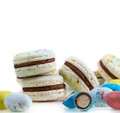 an assortment of cookies and marshmallows on a white background with sprinkles