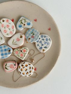 a white plate topped with lots of heart shaped buttons