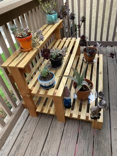 several potted plants are sitting on a wooden shelf outside in front of a deck