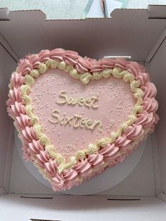 a heart shaped cake in a box with the words sweet sixteen written on it's side