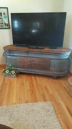 a flat screen tv sitting on top of a wooden stand