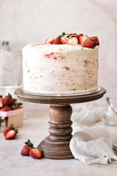 a white cake with strawberries on top