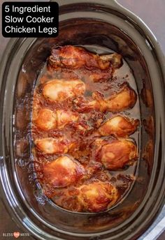 the slow cooker is full of chicken legs with sauce in it and text that reads, 5 ingredient slow cooker chicken legs