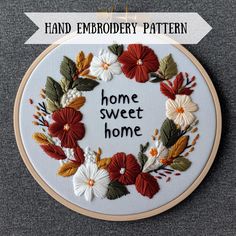 a hand embroidery pattern with the words home sweet home surrounded by red and white flowers