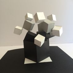 an abstract sculpture made out of black and white cubes