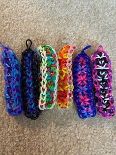 five different colored bracelets are on the floor