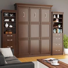 a living room filled with furniture and bookshelves next to a wall mounted bookcase