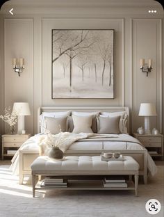 a white bed sitting in a bedroom next to two lamps and a painting on the wall