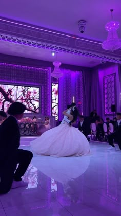 the bride and groom are sitting on the dance floor