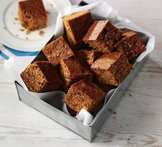 there are several pieces of cake in the box on the table next to each other