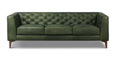 a green leather couch with wooden legs