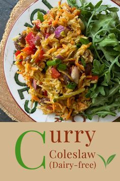 a white plate topped with salad next to a green leafy salad and the words curry coleslaw dairy - free