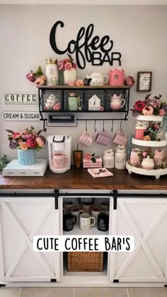 a coffee bar is decorated with pink flowers and other decor items, such as cakes