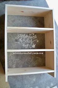 a wooden shelf with some writing on it