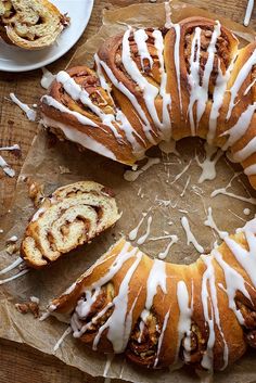 a bundt cake with white icing sitting on top of a wooden table