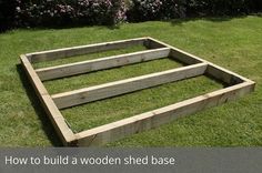 a wooden bed frame sitting in the grass